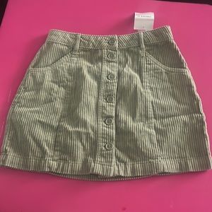 Woman’s corduroy skirt  (New ) size small green with buttons down the middle